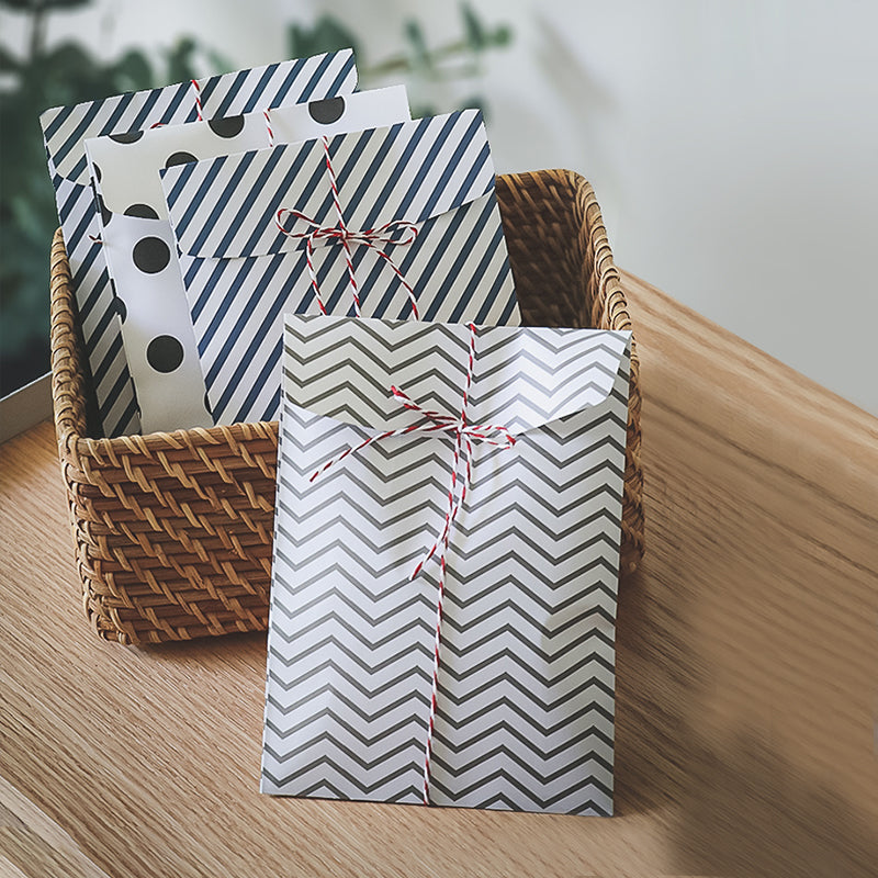 Striped and chevron gift pouches in a woven basket